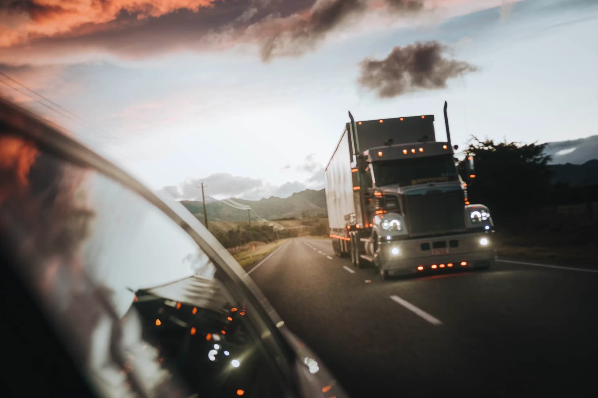A tractor-trailer running a route at dusk